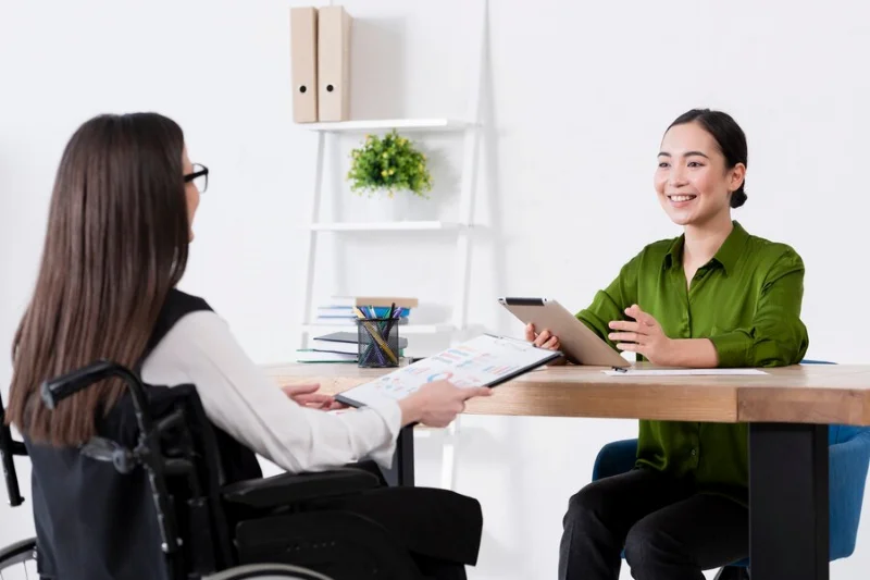 Hai người trao đổi qua bàn làm việc